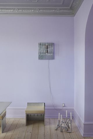 Lilac interior with metal chair, candelabra on the floor and wall light
