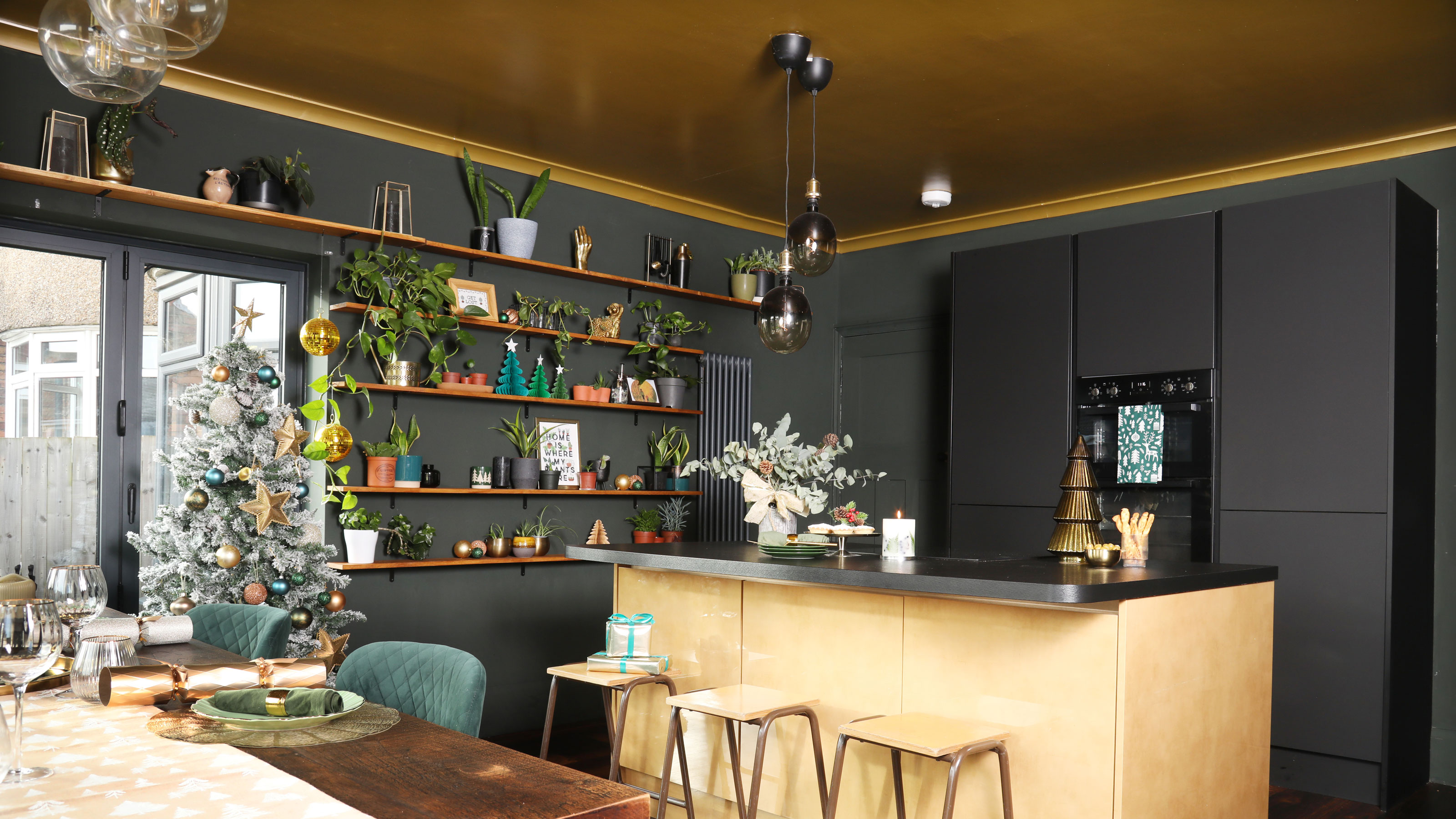 Navy kitchen with gold ceiling and neutral kitchen island