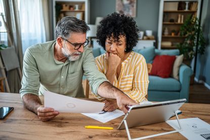 Mature couple feeling worried while trying to get their finances in order
