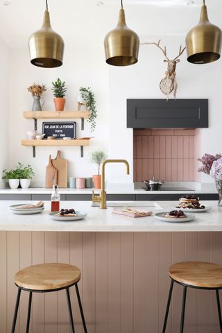 Steve and Katelin Haworth’s industrial grey kitchen has been lifted with a pop of blush pink