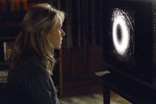 Naomi Watts watches the cursed videotape in The Ring