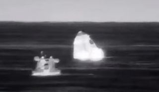 SpaceX's Crew-2 Dragon Endeavour bobs in the Gulf of Mexico after a successful splashdown off the coast of Pensacola, Florida in this thermal image captured on Nov. 8, 2021.