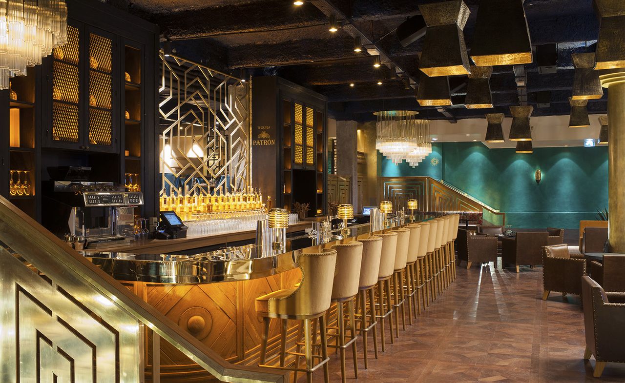 Bar area of the restaurant decorated with dark wood &amp; gold