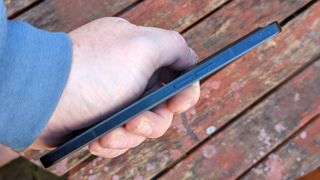 An Oppo Reno 8 Pro smartphone sitting on a rustic table