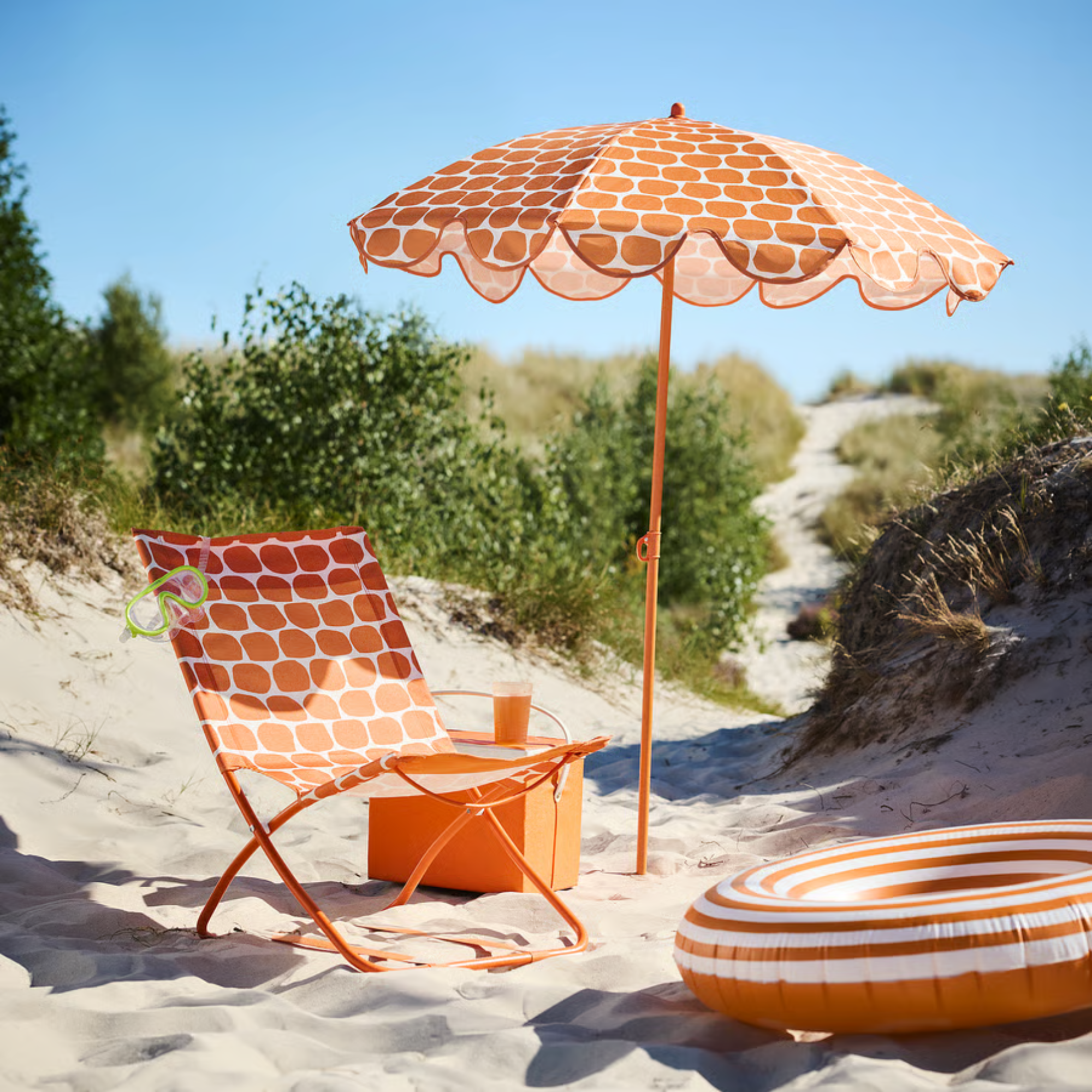 IKEA STRAND&Ouml;N parasol and chair in orange on a beach.
