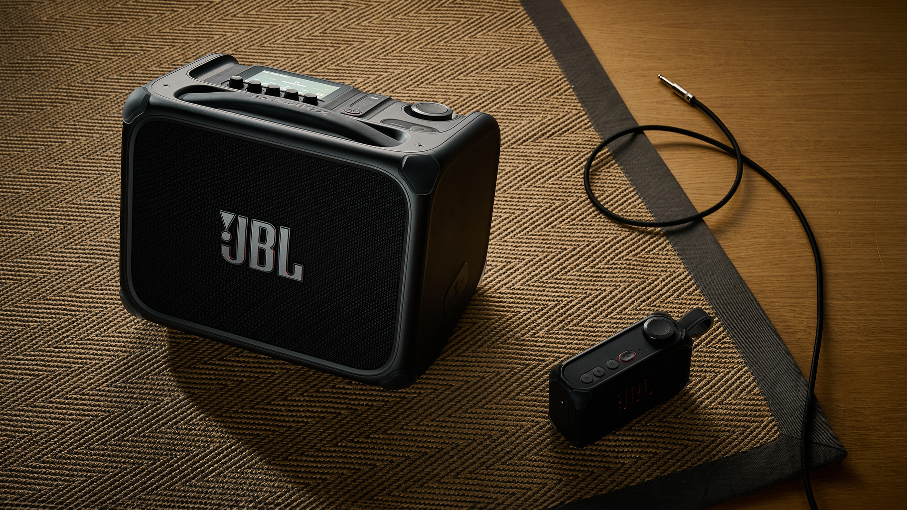 A JBL BandBox Trio guitar amp BandBox Solo practice amp on a rug