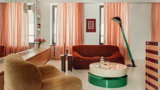 Sheer salmon-colored curtains soften the light across a living room interior full of glossy surfaces