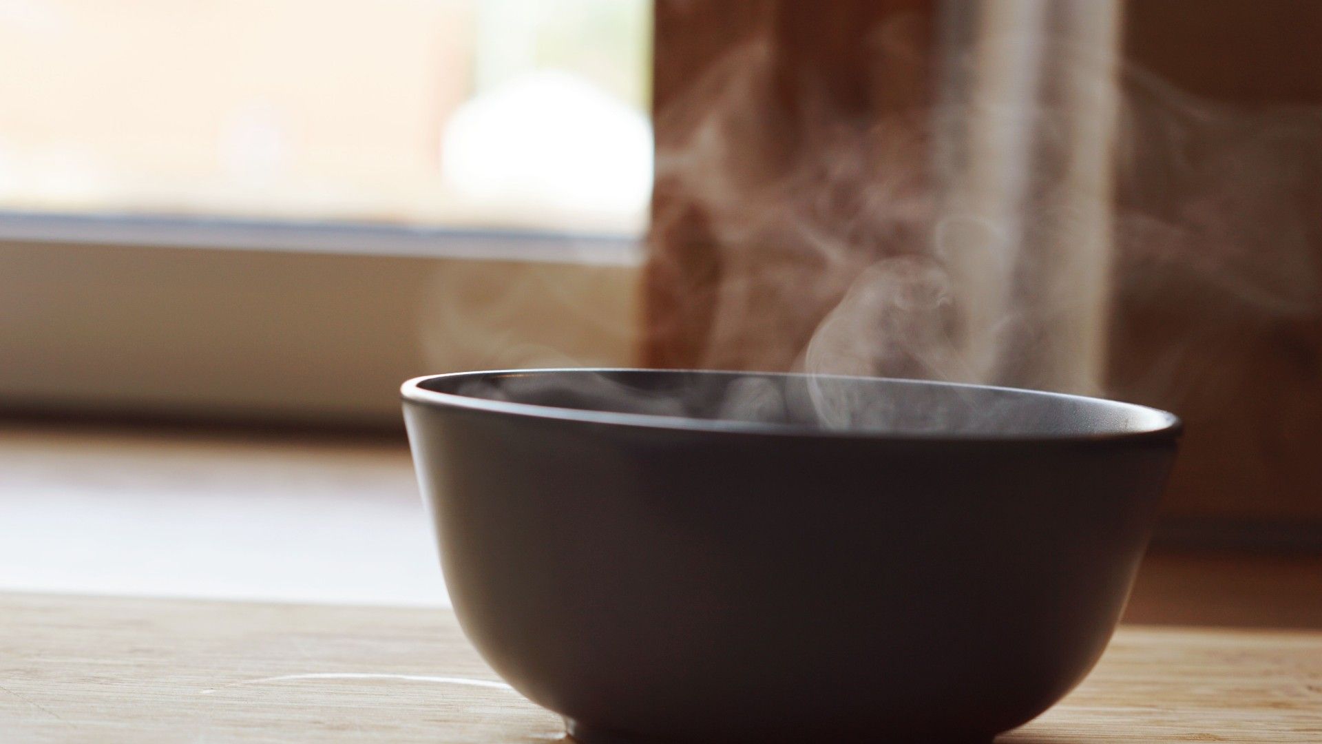 a bowl of hot water steaming in a kitchen