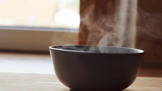 a bowl of hot water steaming in a kitchen