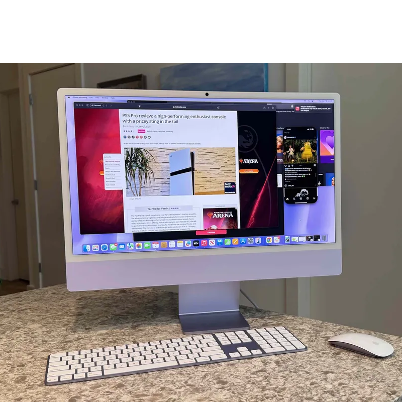 An iMac on a counter with its included keyboard and mouse