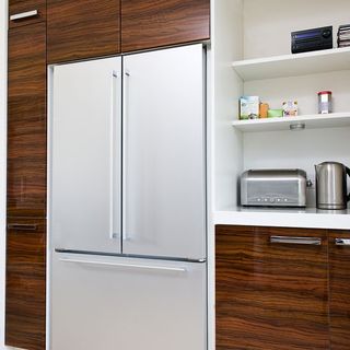 kitchen room with cabinetry fridge freezer