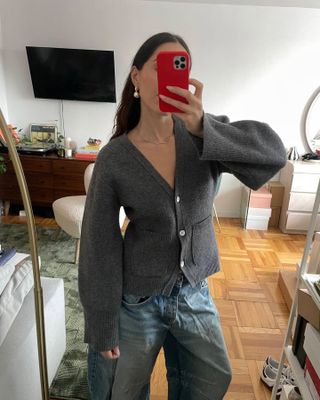 Anna LaPlaca wearing a gray Almina Concept V-Neck Cardigan