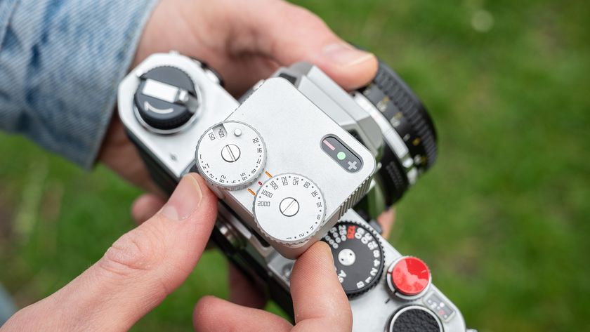 Close-up of TTArtisan Light Meter II on a Nikon FM being held out in the field 