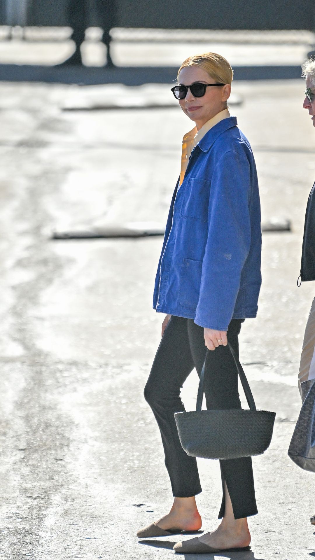 michelle williams wearing a blue overshirt and black split flare trouser