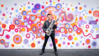 Matt Bellamy poses with a Manson META Series electric guitar