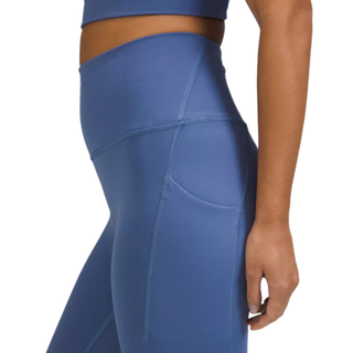 side view of blue lululemon leggings with a side pocket