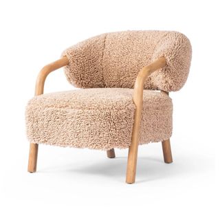 A wooden chair with boucle upholstery