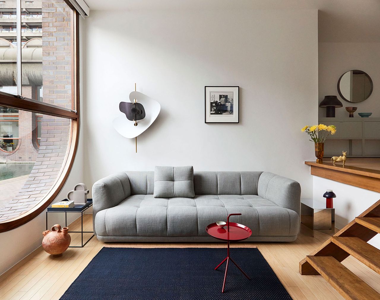 apartment living room with white walls and modern wall light