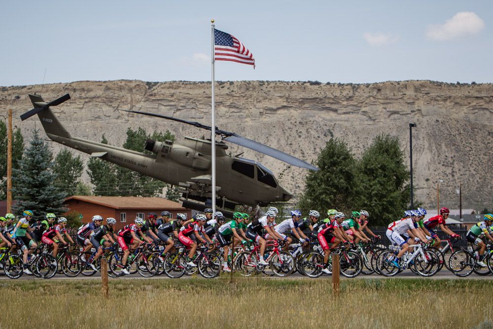 Riders pass a helicopter along the course.