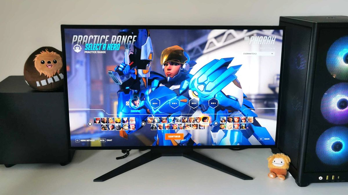 Corsair Xeneon 27QHD240 monitor on white desk with Overwatch 2 character select menu on screen