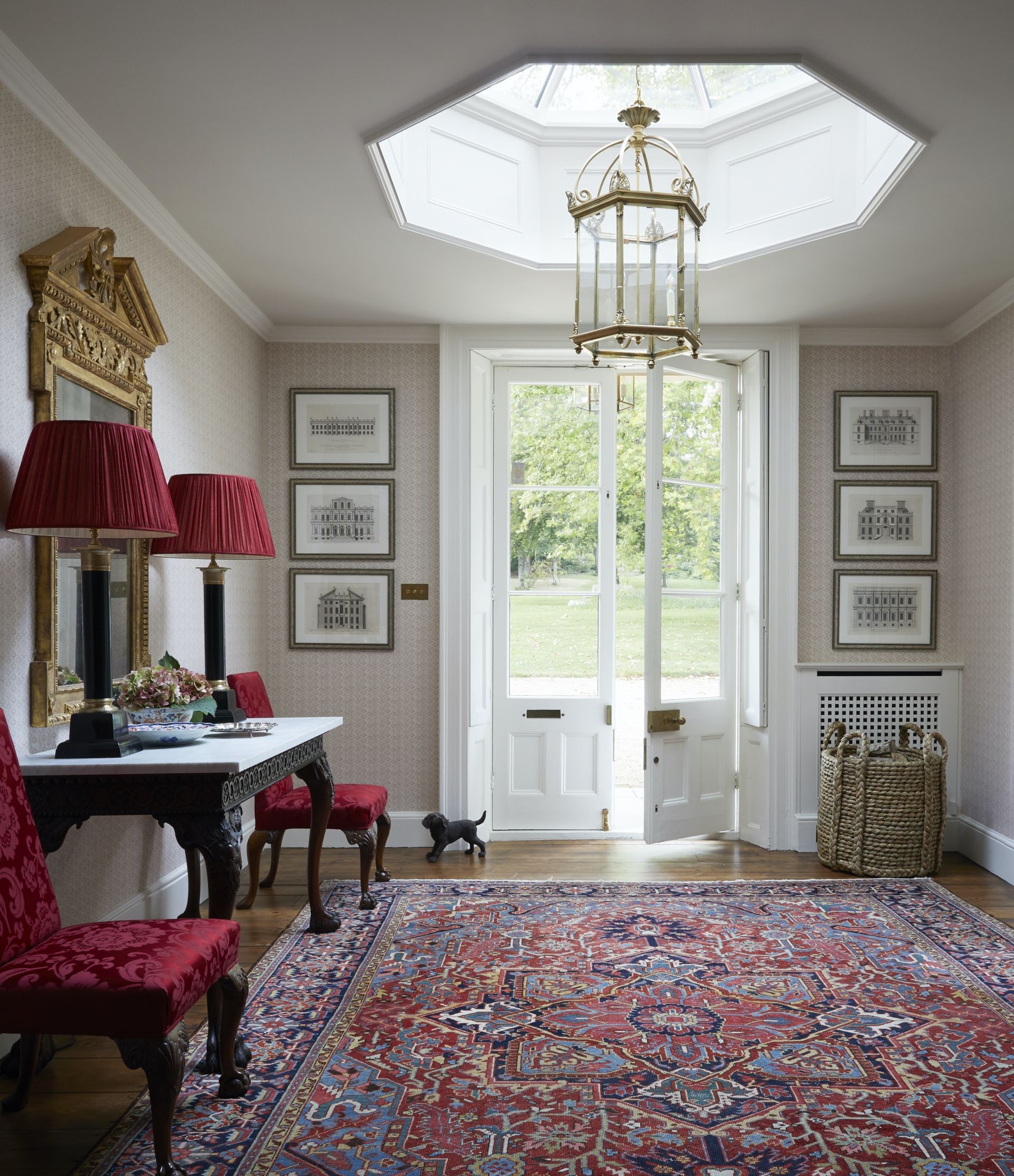 Pink diamond shape wallpaper patter, red cushion chairs and lampshades