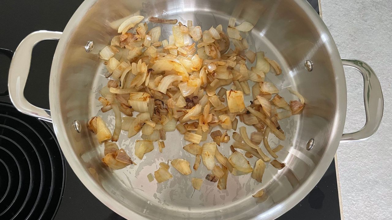 Onions in a pan from the ProCook Professional Stainless Steel Uncoated Cookware Set