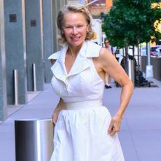 Pamela Anderson wears a white dress