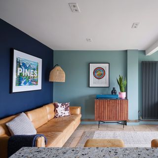Living area with blue painted walls and leather sofa