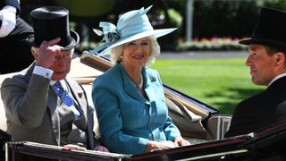 Prince Charles, Prince of Wales, Camilla, Duchess of Cornwall and Peter Phillips arrive in an open carriage to attend Royal Ascot 2022 at Ascot Racecourse on June 14, 2022 in Ascot, England.