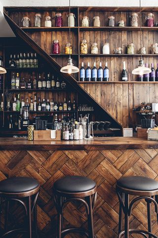 Bar with wood and black leather bar stool Rök Smokehouse — London, UK