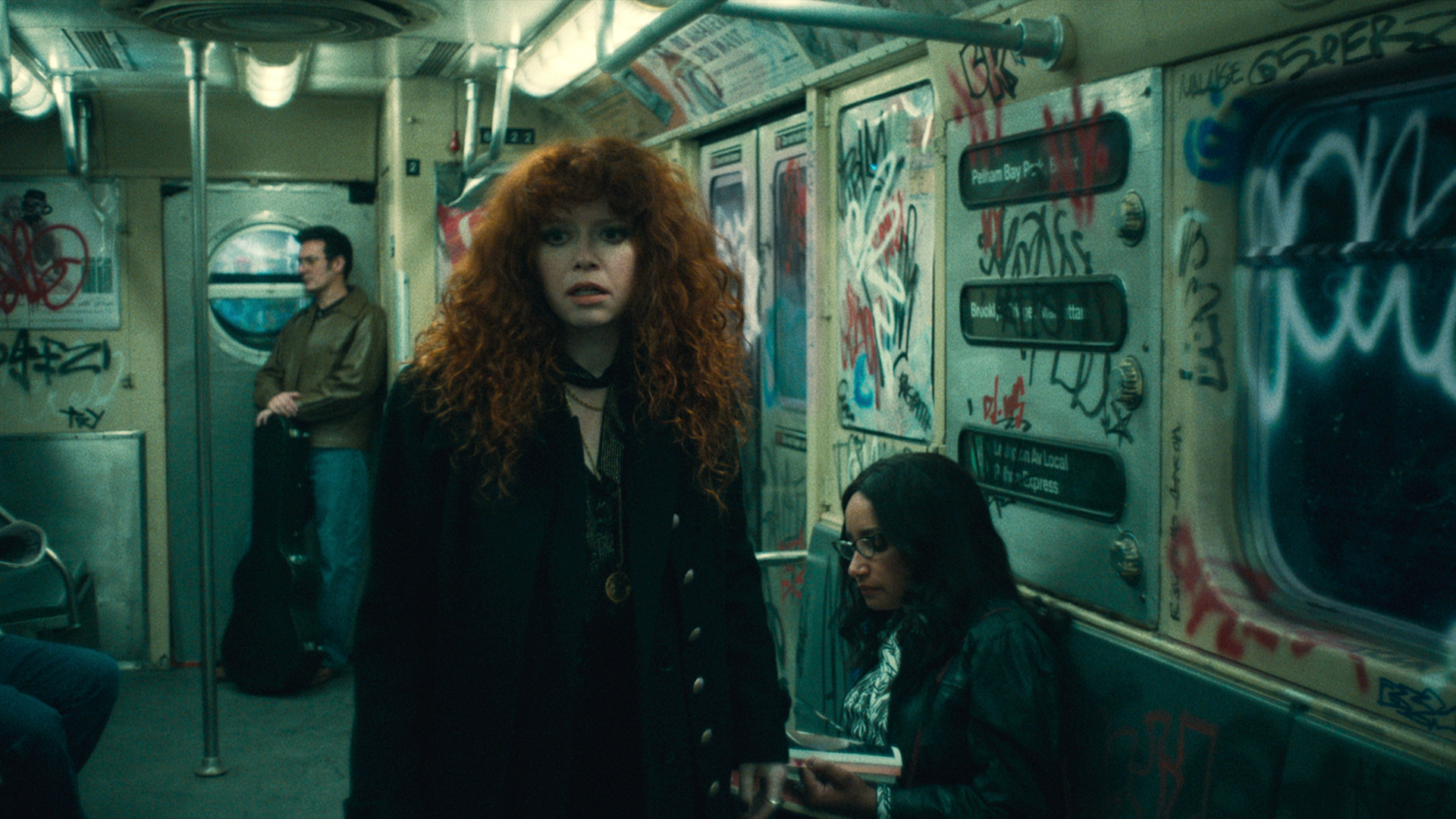 Nadia looks uneasy as she stands on a subway train in Russian Doll season 2