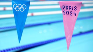 Bunting showing the Paris 2024 logo above the Olympic swimming pool.