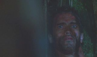 Arnold Schwarzenegger looking at the Predator