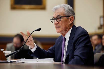 Federal Reserve Chair Jerome Powell speaking into microphone in congressional testimony