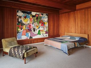 Bedroom with large colourful artwork