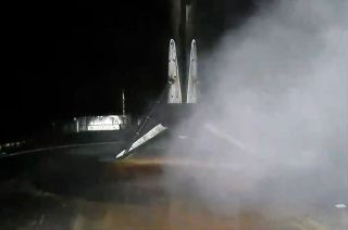 A rocket booster sits on a droneship after landing from space