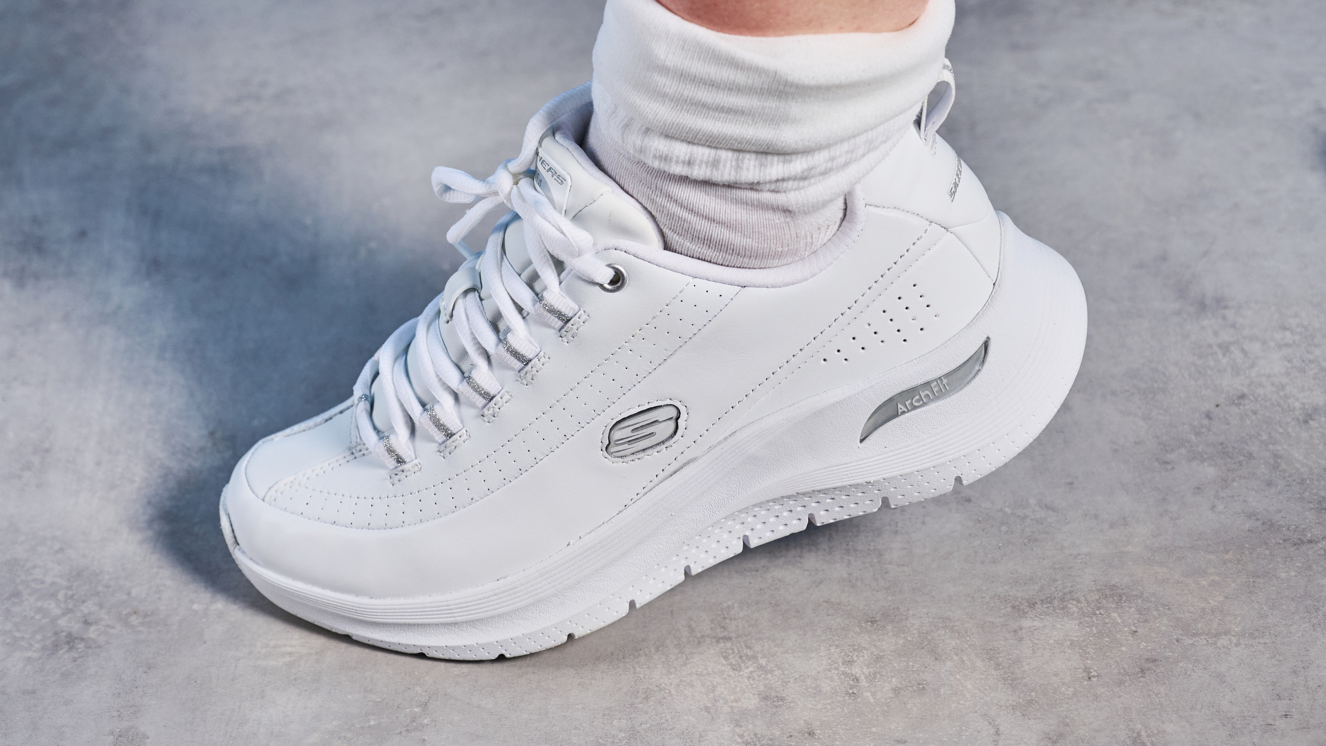 Skechers Arch Fit 2.0 Star Bound photographed in front of a blue background.