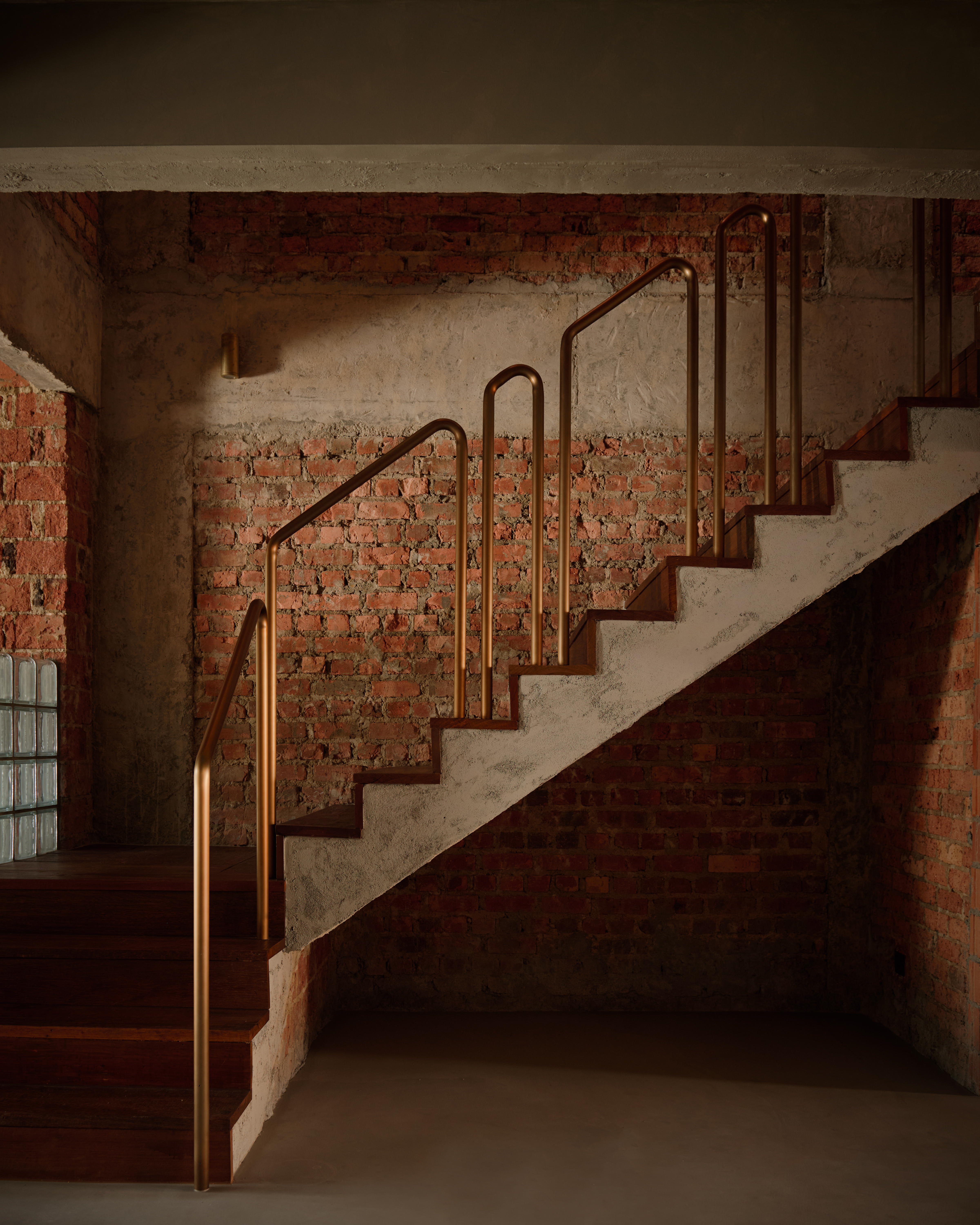 'My last home' by L Architects, a raw interior space of exposed brown brick and wood detailing