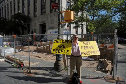 A protestor outside of the Epstein trial.