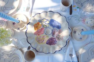 an oyster plate with colorfully painted recesses