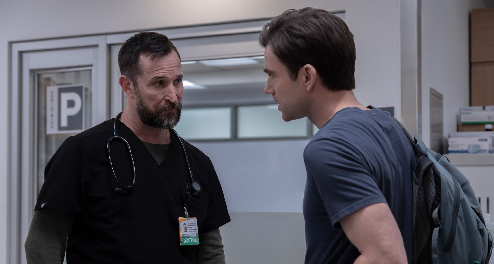 noah wyle as dr. robby having a conversation with patrick ball as langdon in tthe hospital hallway in the pitt season 2 finale 