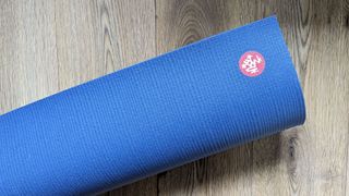 Manduka PRO yoga mat on a wooden floor