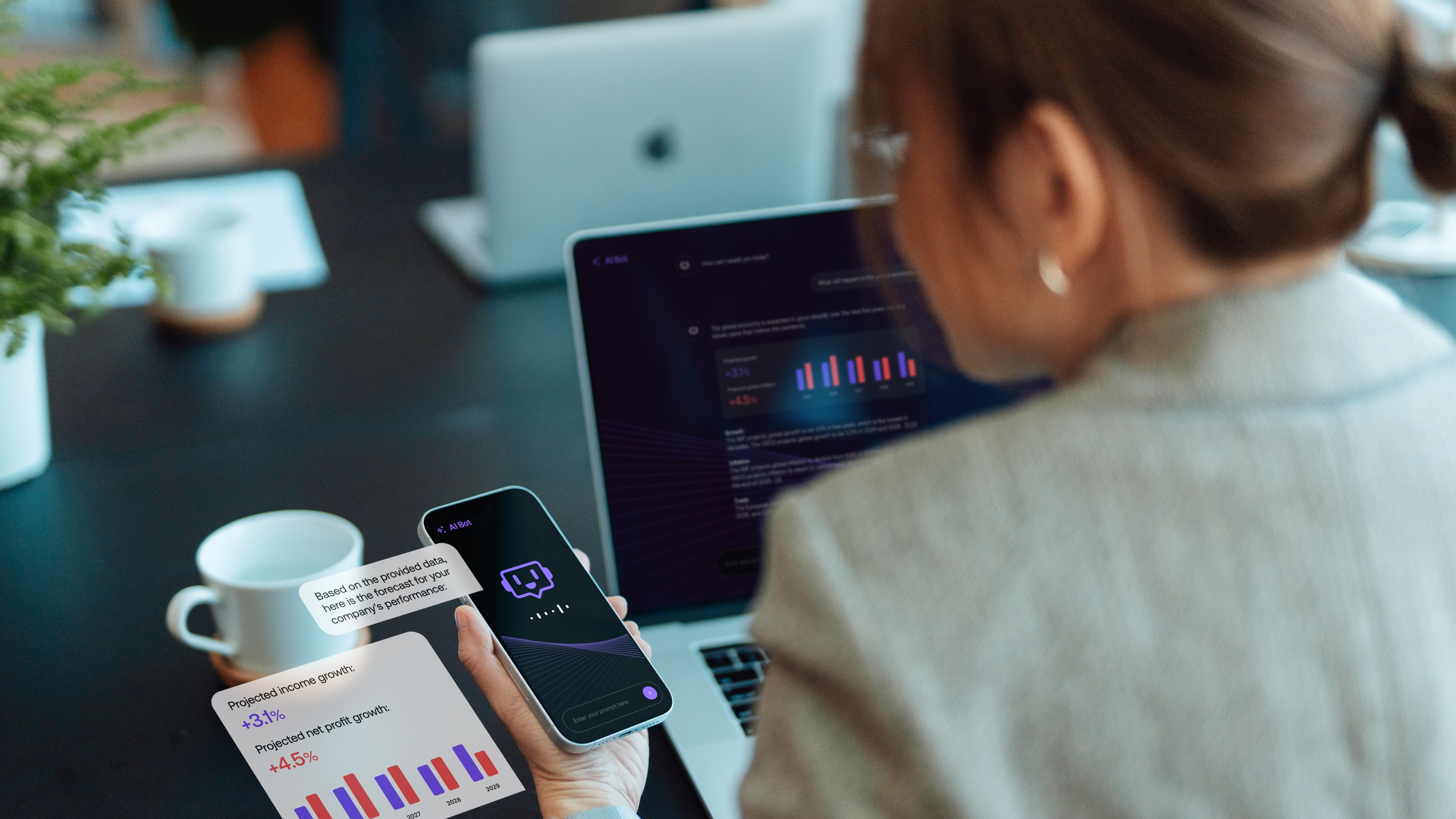 An office worker uses AI on her phone while sitting at her desk and laptop.