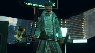 A man in a soldier's uniform faces the camera holding a sledgehammer