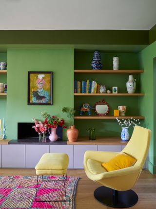 Green living room with shelving and yellow chair