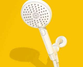 sproos! shower head in white on a yellow background