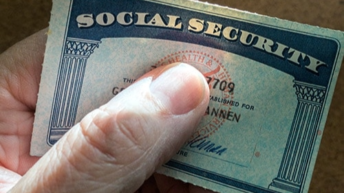 A person holding their Social Security card.