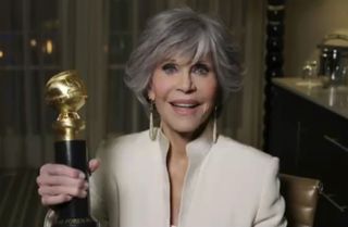 Jane Fonda holding her Golden Globe. 