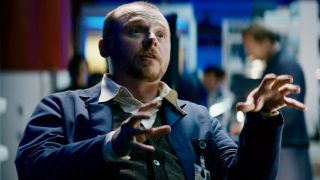 Simon Pegg gestures with his hands as he sits in conversation in Mission: Impossible III.