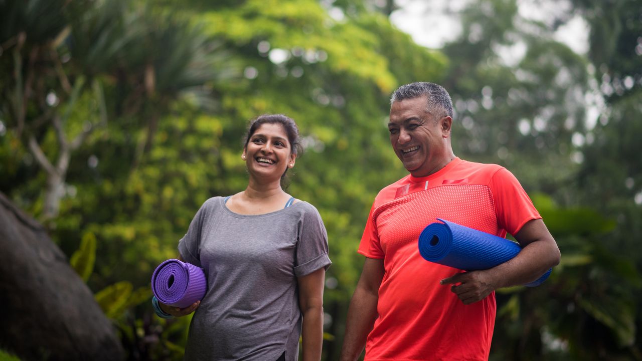 Active seniors with exercise mats